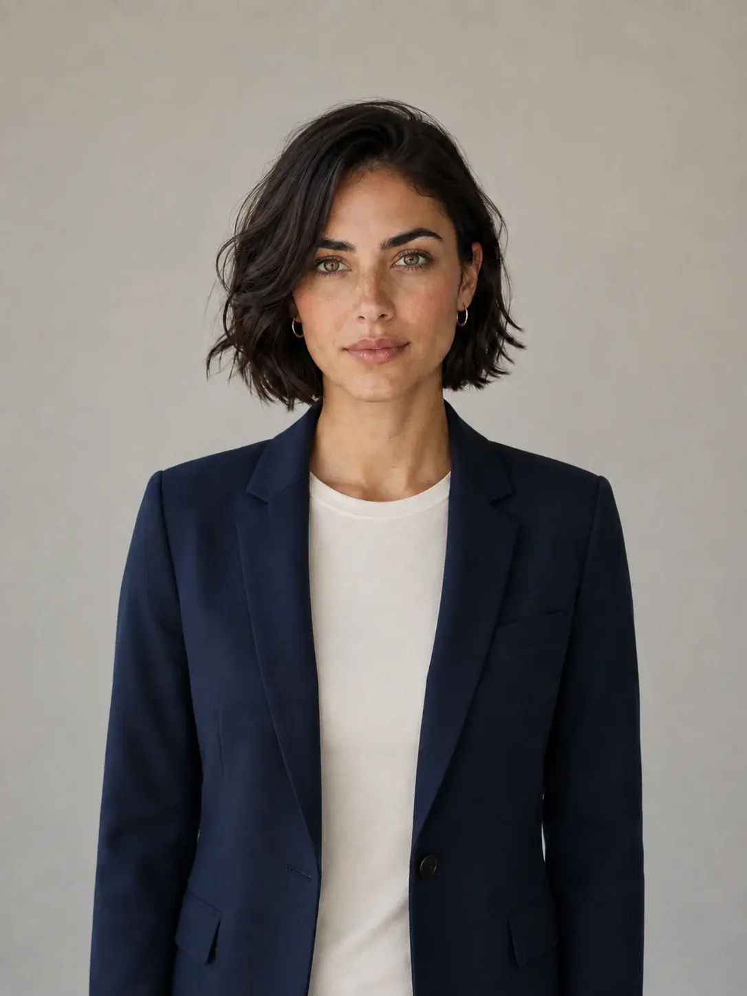 Mira wearing a navy blazer and white T-shirt
